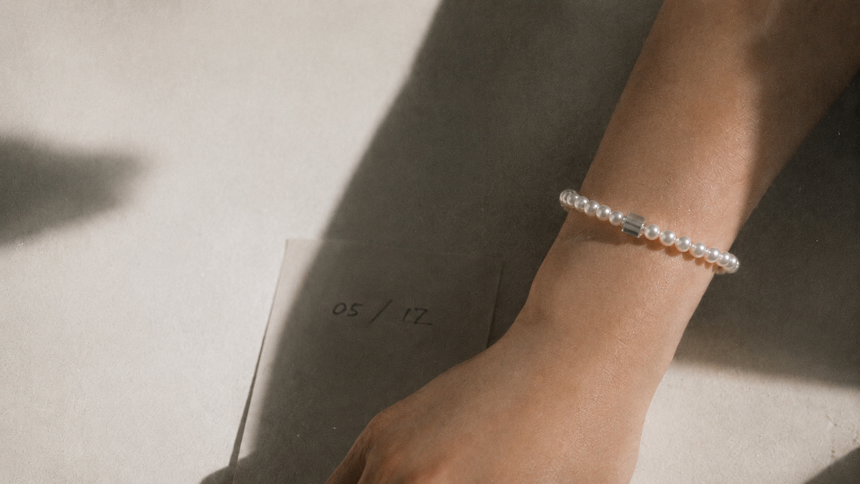 Day and You pearl bracelet worn on wrist