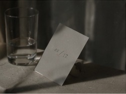 A dated card beside a glass